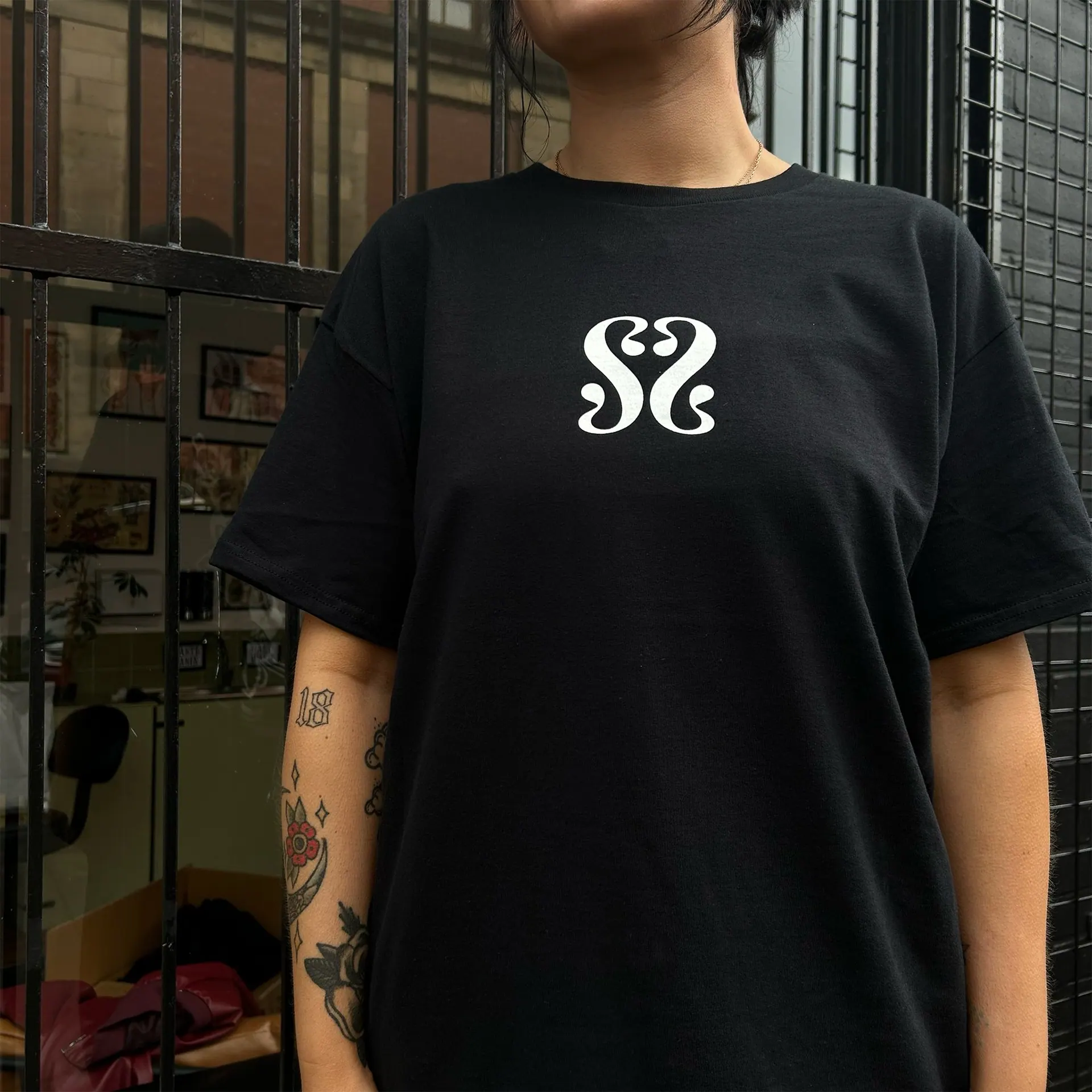 The Someday Soon logo tee, photographed at the studio entrance